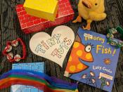 Tiny Tots logo surrounded by an assortment of toys and picture books