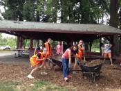 Moving mulch the Rustic Shelter area with International Students