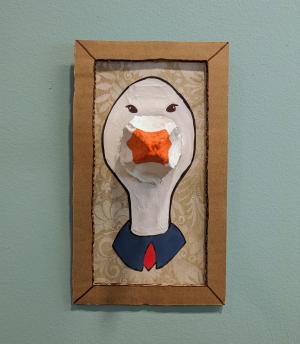 Photo of a portrait of a goose, painted on pieces of cardboard and egg carton.